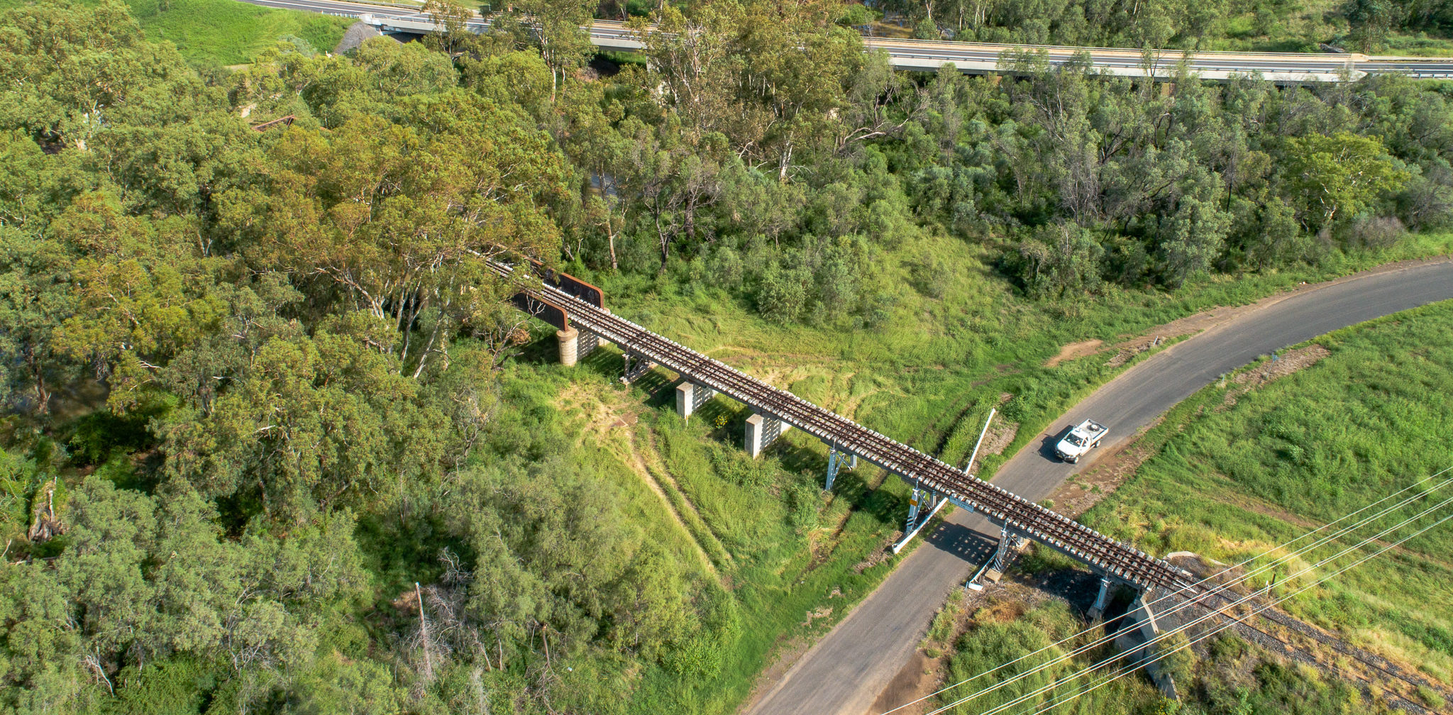 Aerial image showing rail bridge crossing road