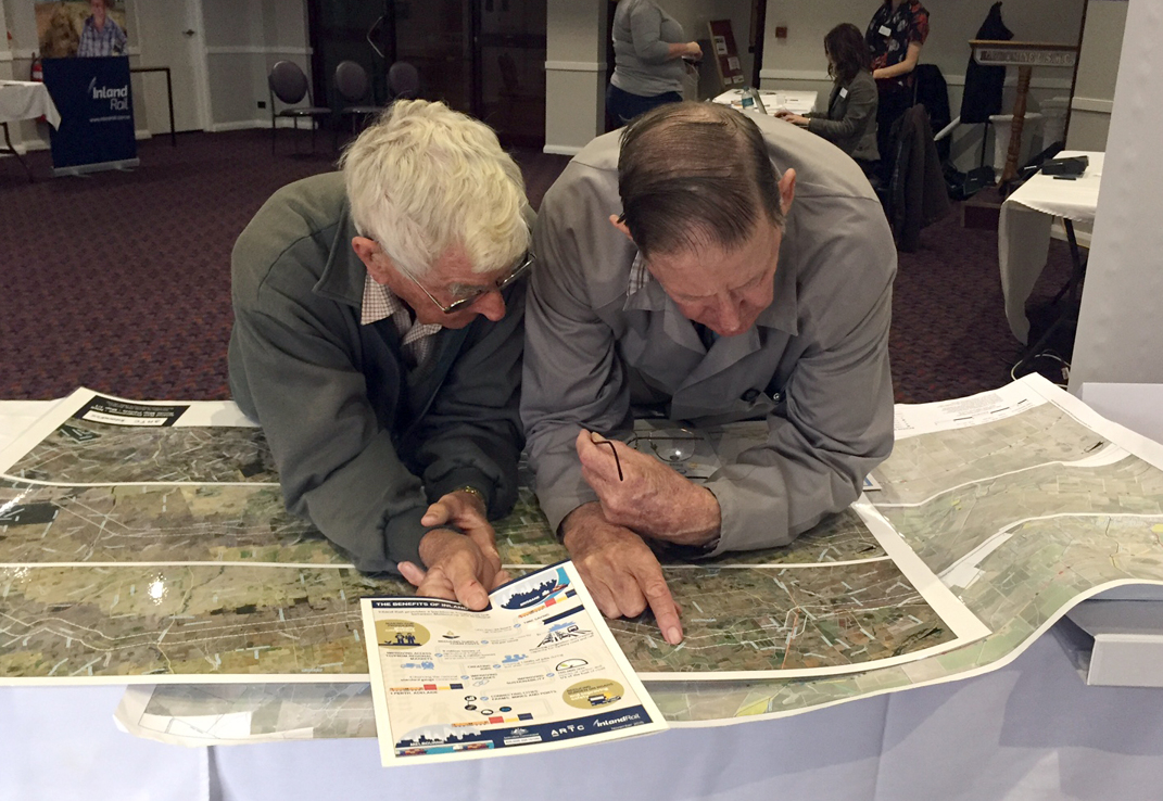 Two people looking at a map during a consultation.