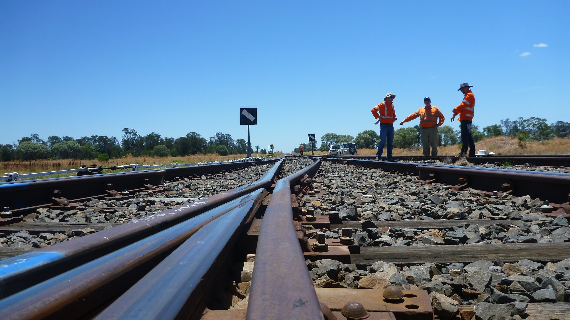 Rail workers on the tracks talking
