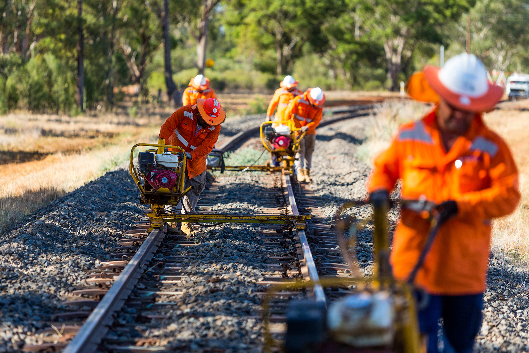 Rail workers on the track performing maintenance outside Parkes, NSW - rail jobs Australia
