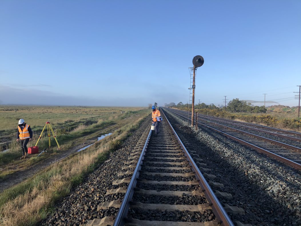 Rail workers carrying out signal surveys on the track