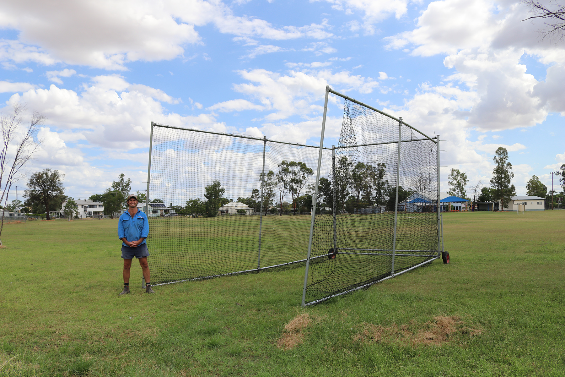 Inland Rail Community Sponsorships and Donations program recipient, Yelarbon Yellow Bellies Secretary standing in front of their new portable cricket nets