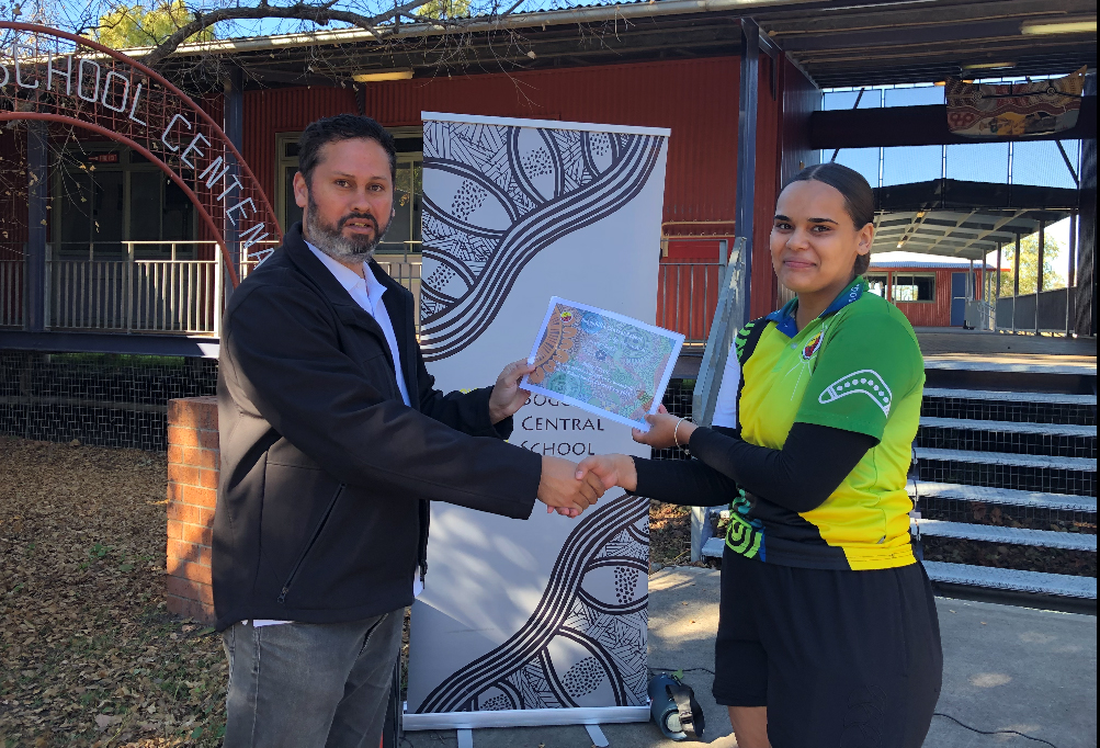 Boggabilla Central School student hands over a certificate of appreciation to Inland Rail Indigenous Participation Coordinator during NAIDOC week celebrations
