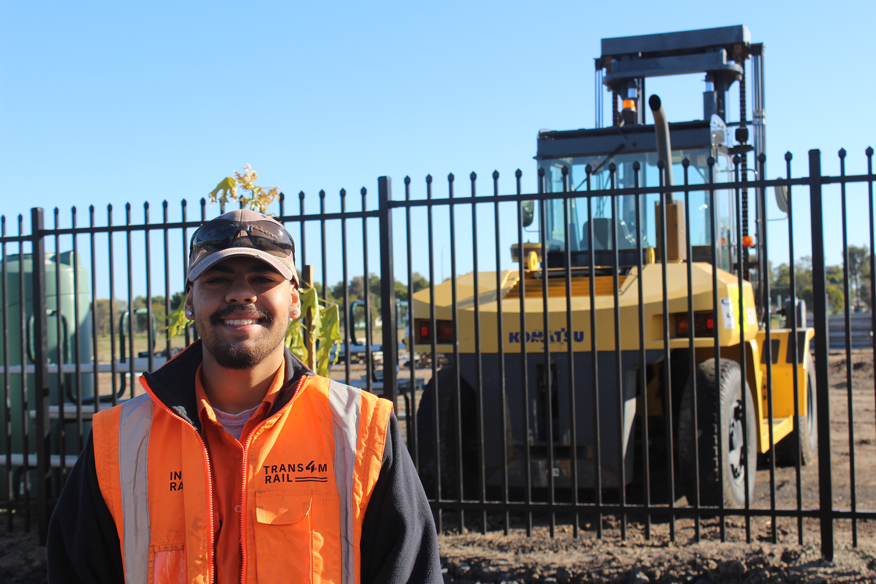 Jedd works as a Civil Labourer and is pictured in front of construction vehicle