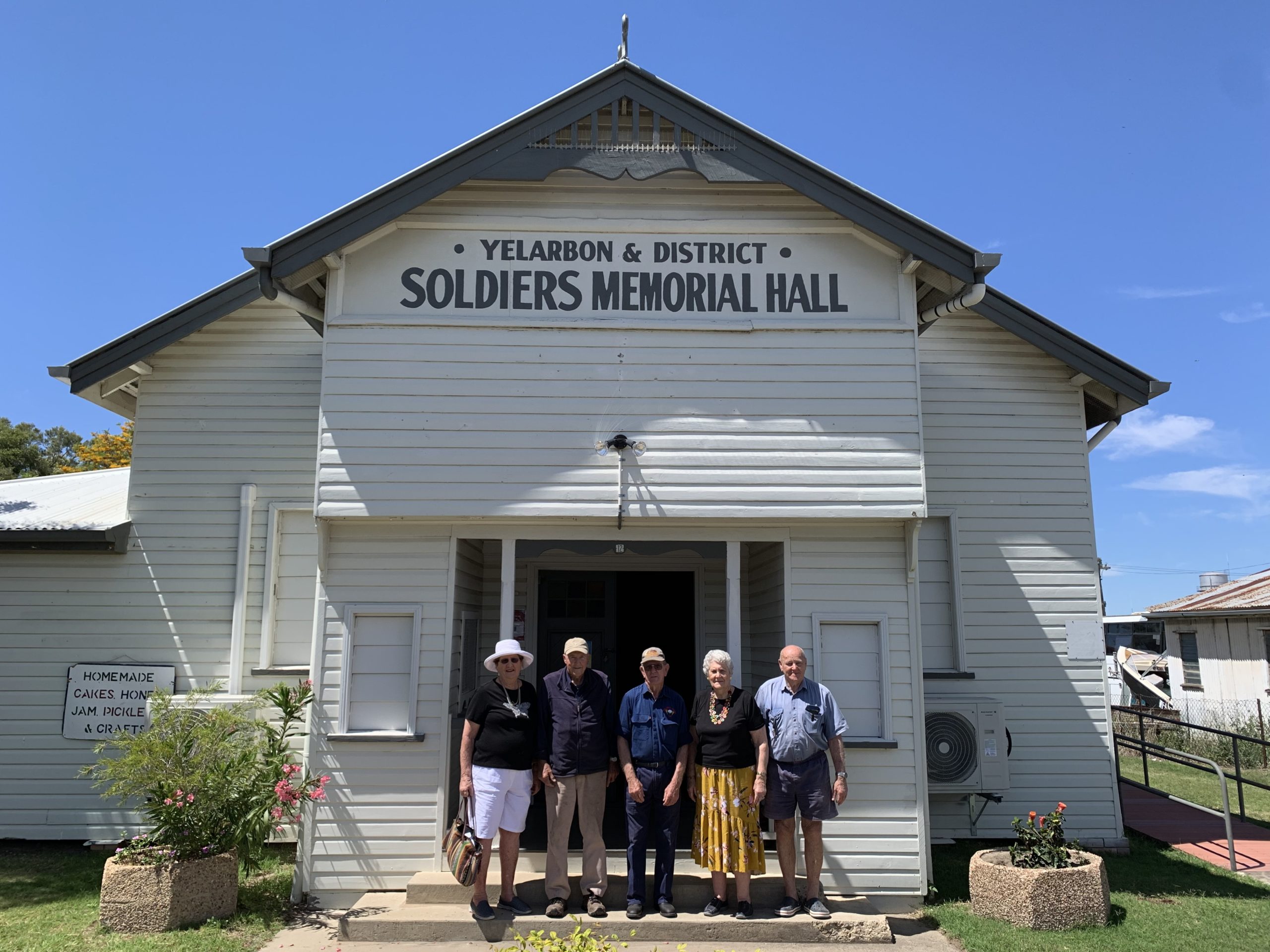 nland Rail Community Sponsorships and Donations Program recipients, the Yelarbon RSL Memorial Hall Restoration Committee, standing in a group out the front of the hall