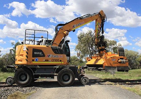 Image of a high rail excavator with a ballast brush