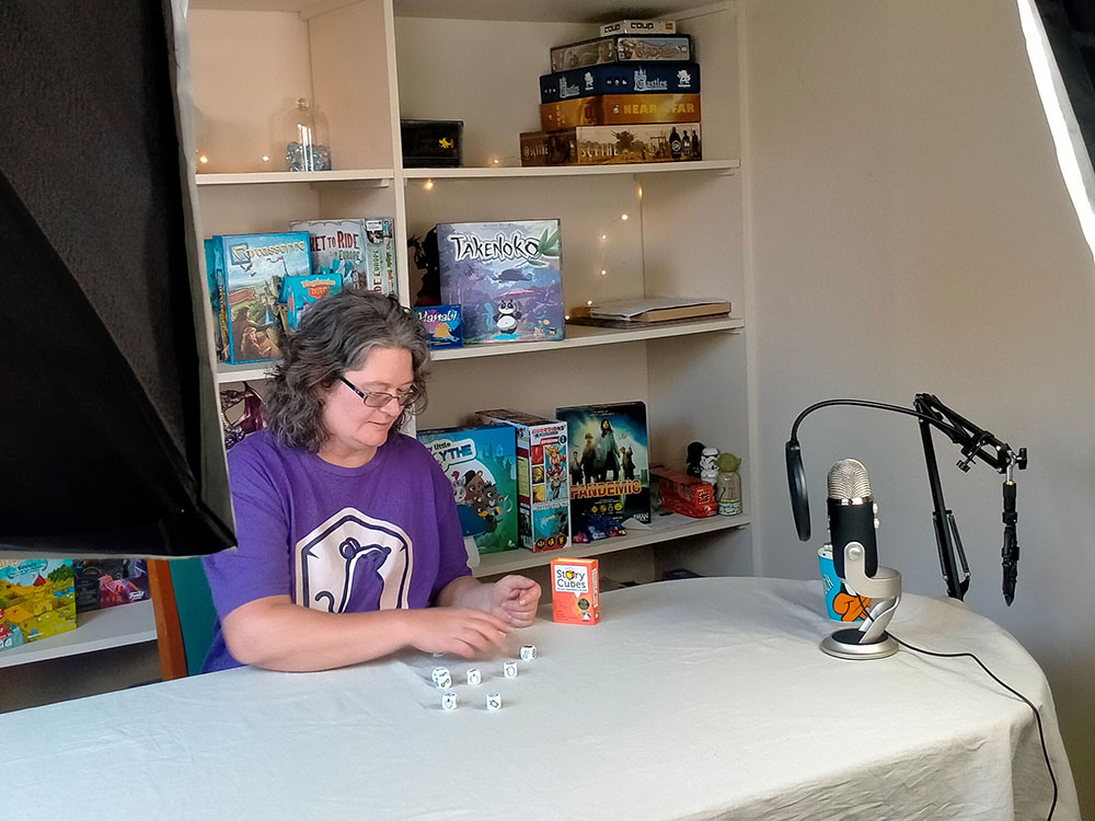 Room at the Table President Carla Gardner in the studio where live stream board games are played