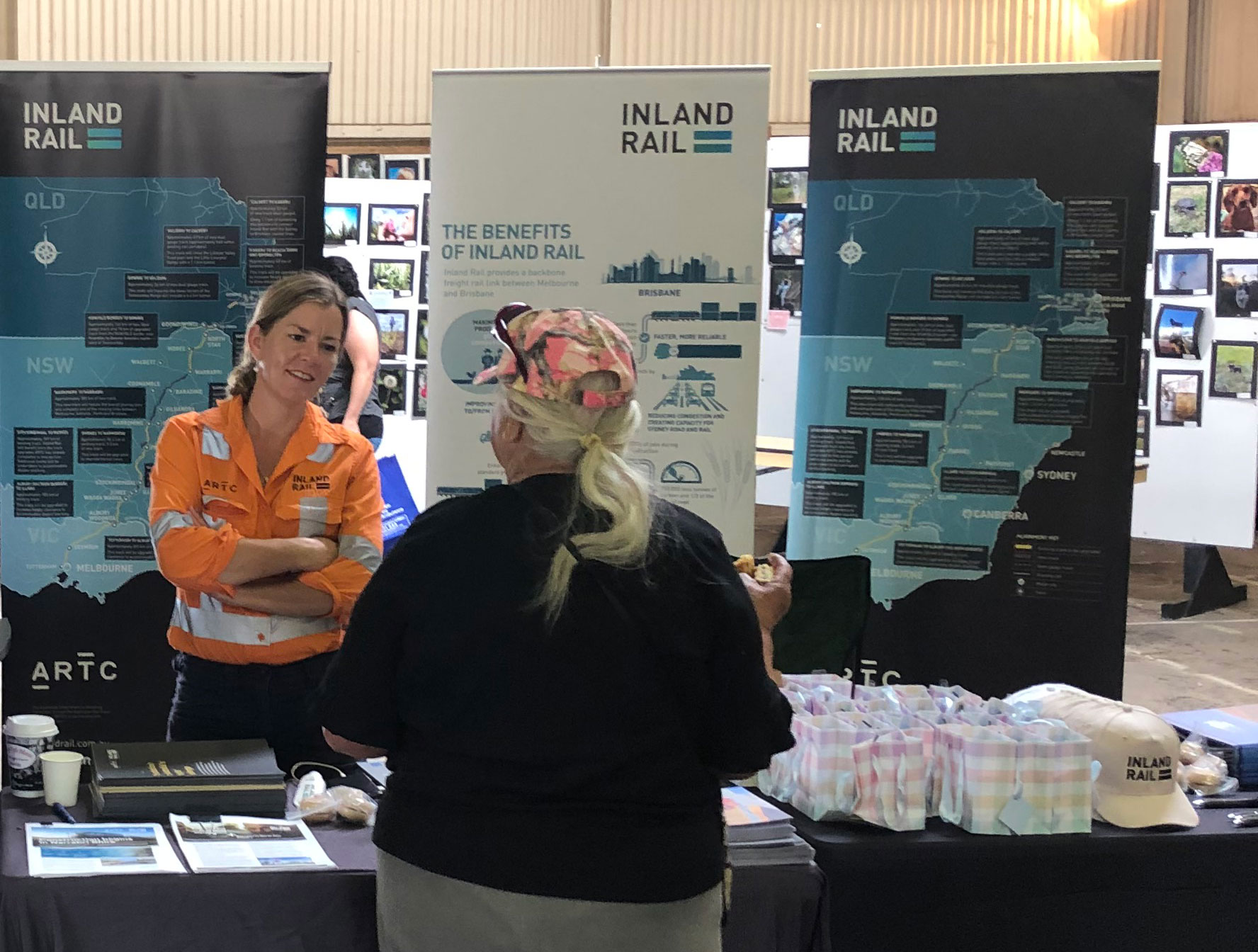 Stakeholder Engagement Manager Isabella Hall speaking with a community member at Inland Rail stand at the Moree Show