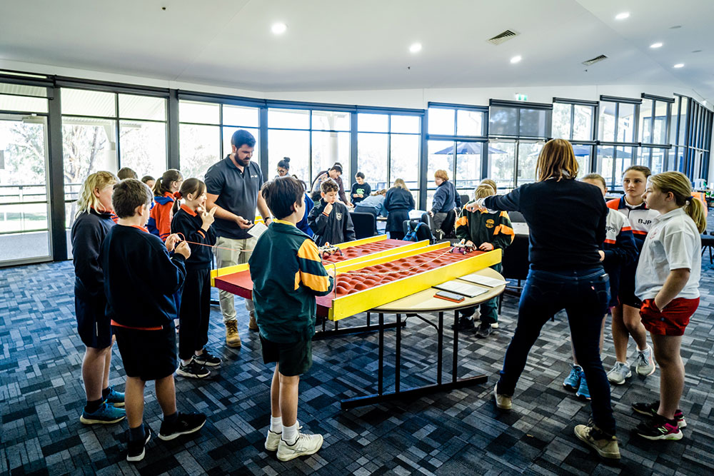 Inland Rail staff helping primary school students with their Mars Rover activity.