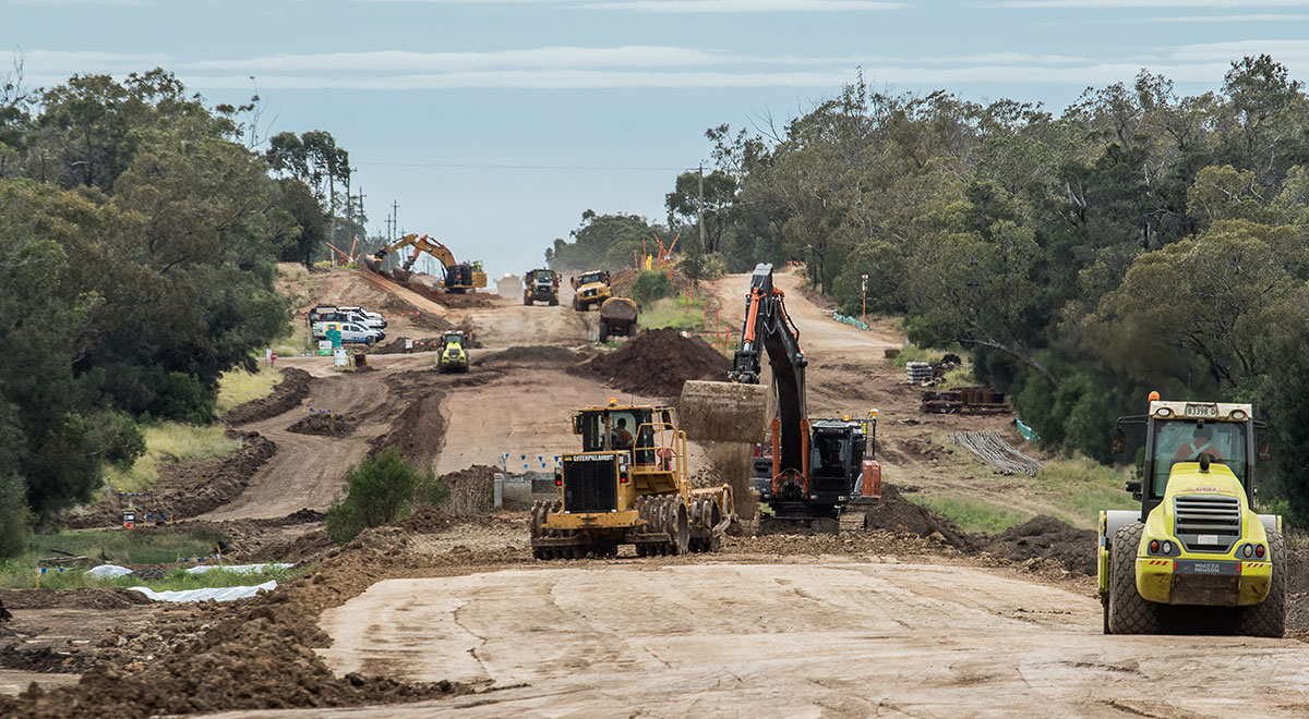 Photo of earthworks in progress along the Narrabri to Bellata section. Excavators, rollers and other earth moving equipment.
