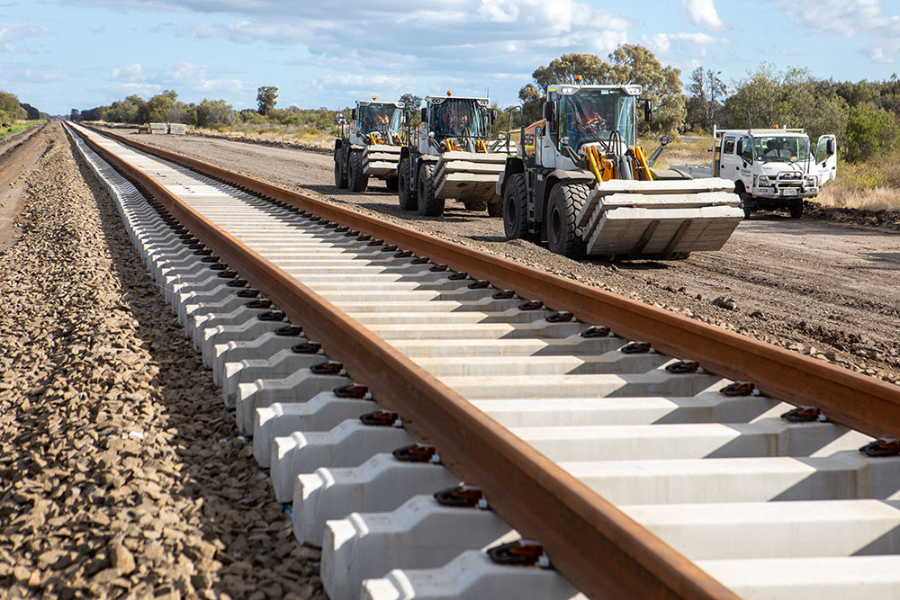 Transportation of concrete sleepers to their location to be layed and new track that has been constructed