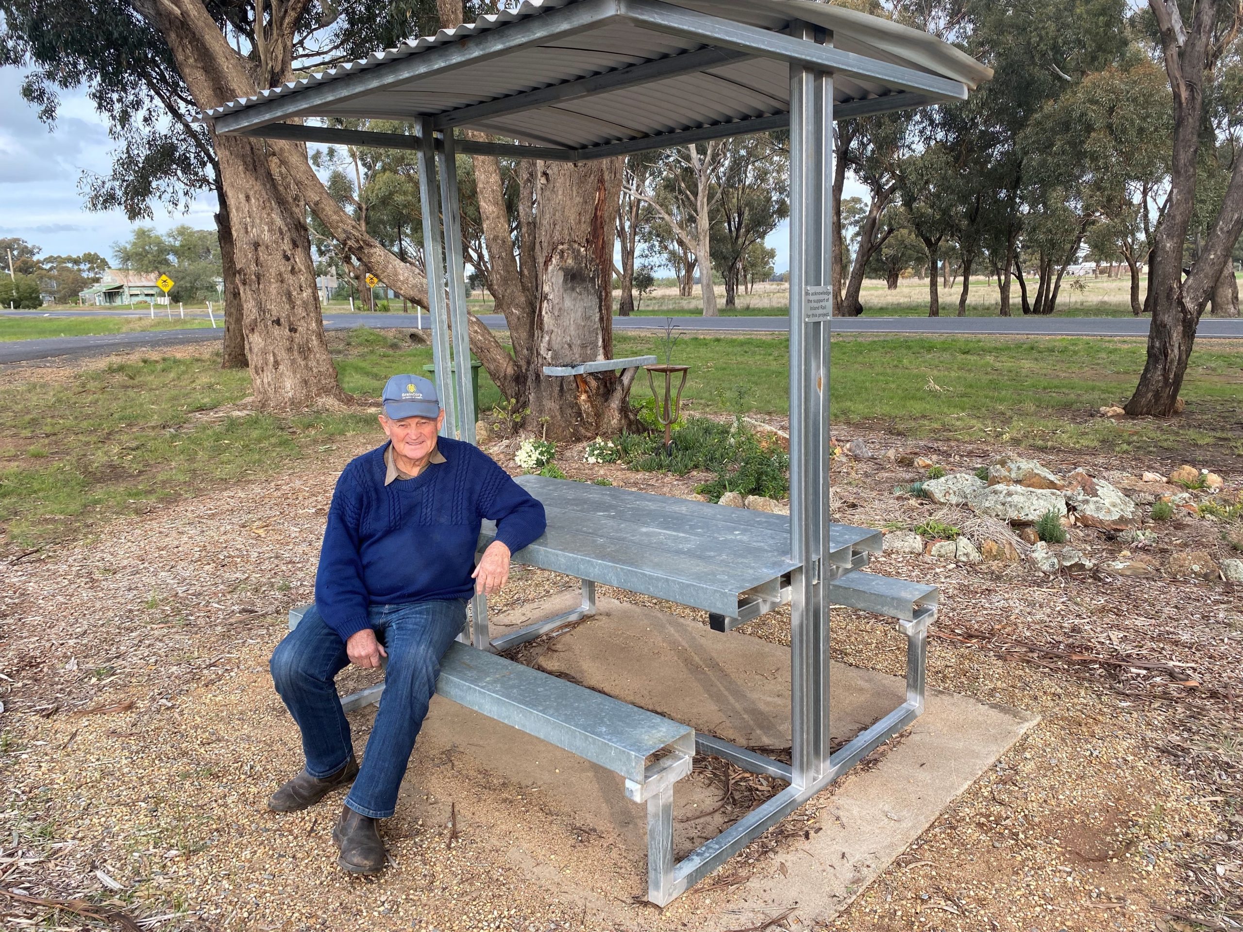 Man sitting on park bench in Milvale Park