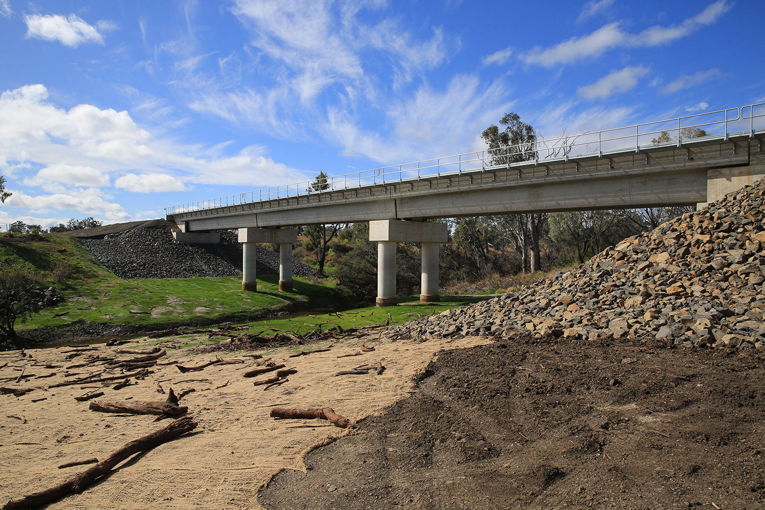 Finished Croppa Creek Bridge with rehabilitated riverbank and koala trees in the background