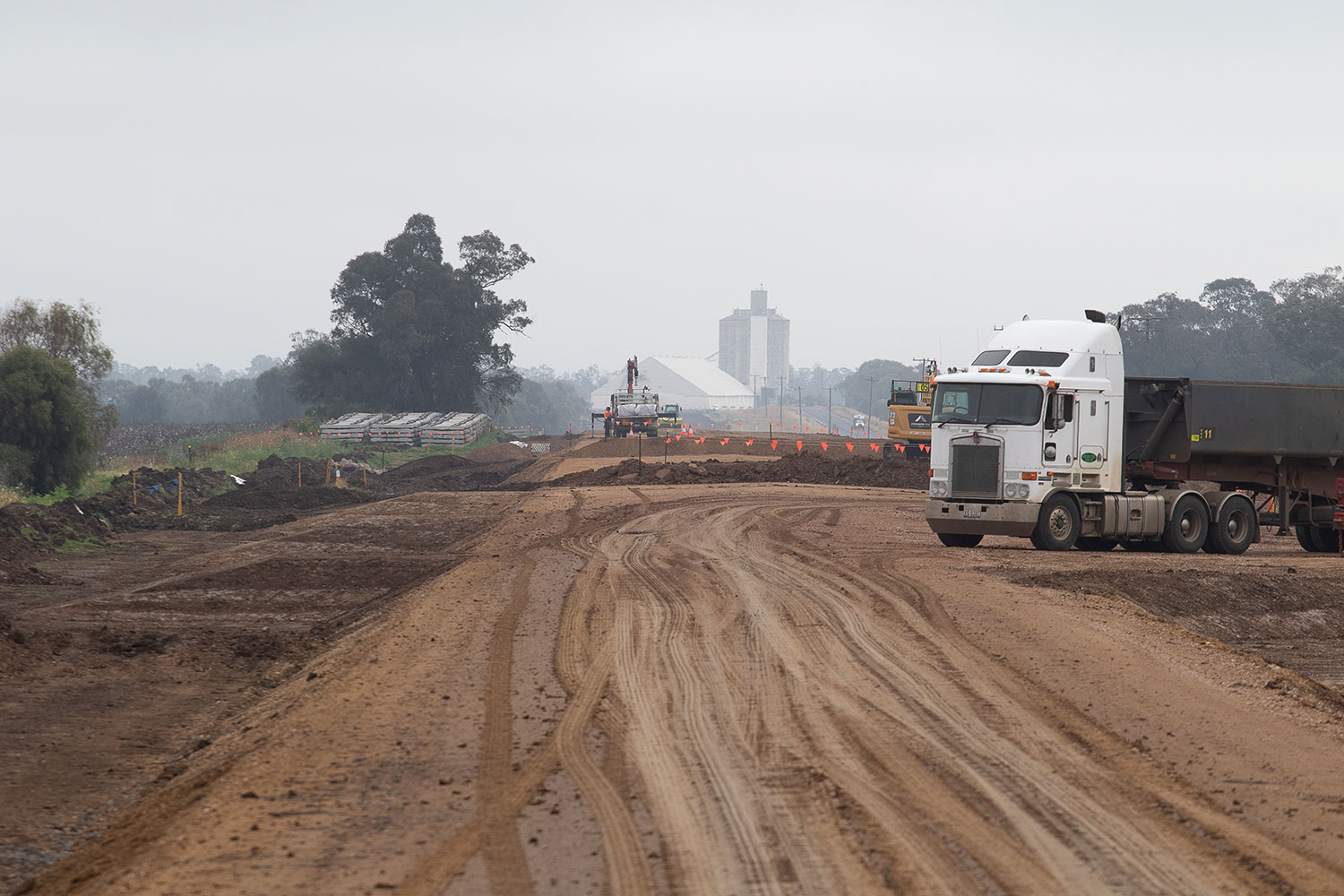 Installation of capping material north of Narrabri, with Edgeroi in the background
