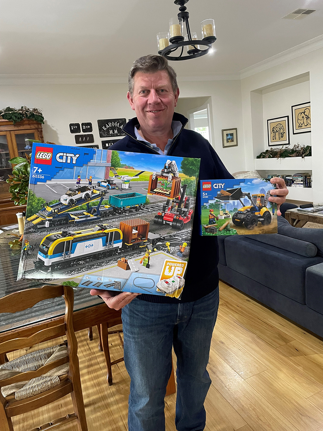 Image of Graham Meredith, winner of the SRES 2023 LEGO competition, holding the two prize sets of LEGO.
