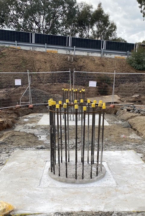This is what the start of a bridge column looks like. Piles are drilled deep into the ground and then a pile cap is poured and backfilled, creating the start of a column.