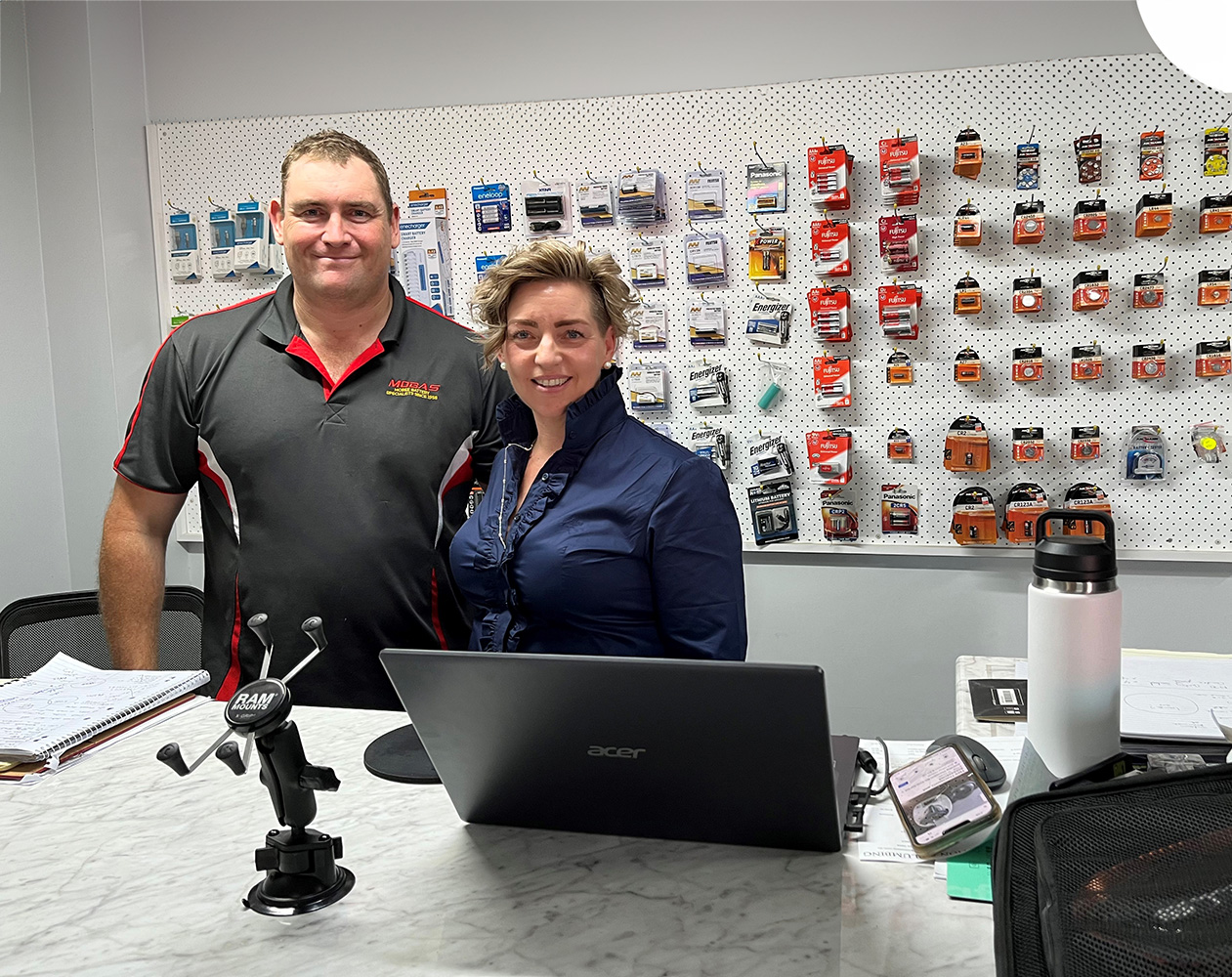 Craig and Melinda Atherton at the front desk of their auto supply business Mobas Batteries