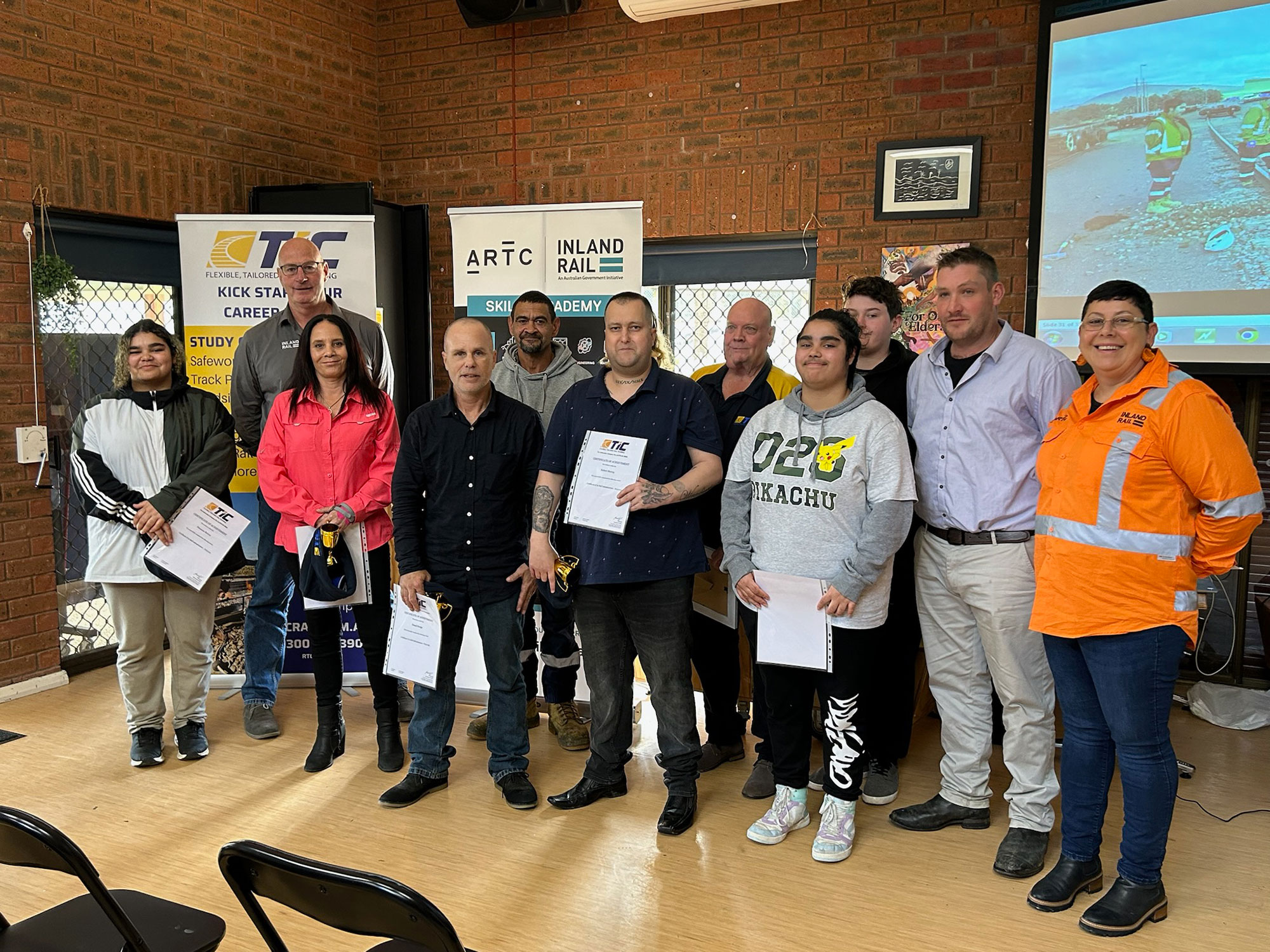 Seven local First Nations students who recently completed a critical five-week course to build their rail infrastructure skills pictured with their Certificate II in Rail Infrastructure