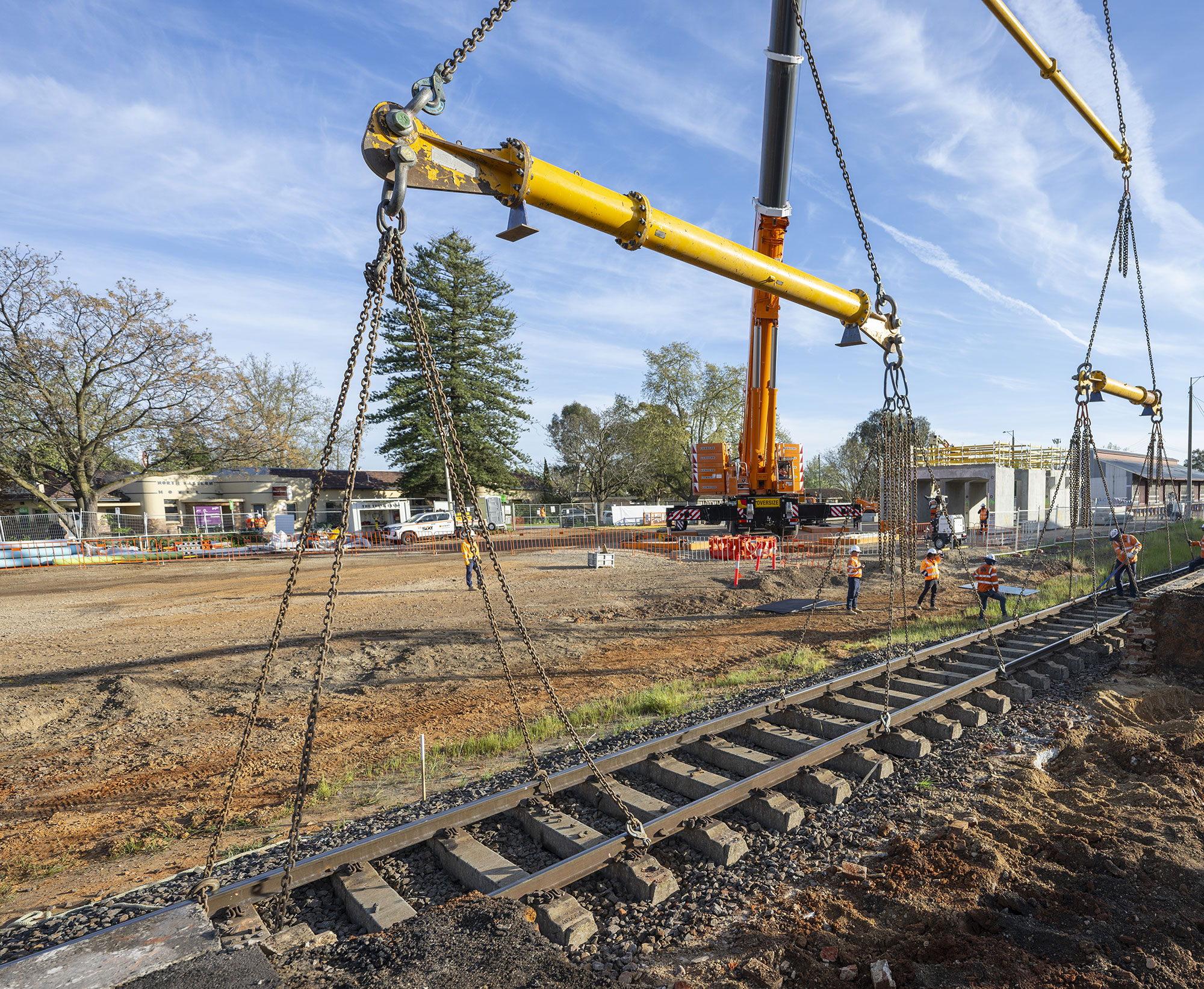 A massive crane is used to lift the existing rail track in Wangaratta