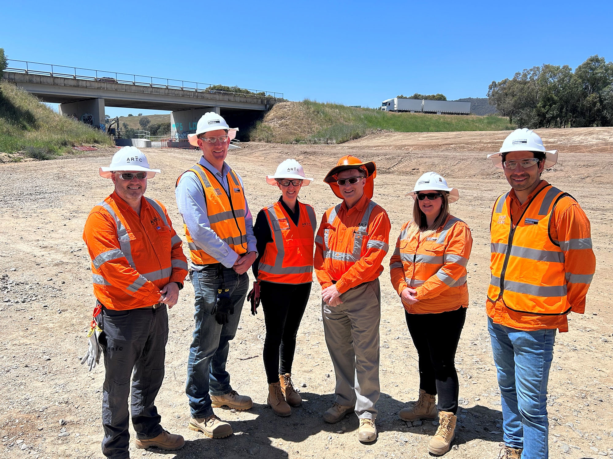 The ARTC and McConnell Dowell teams inspect the new lowered track at Murray Valley Highway, Barnawartha North