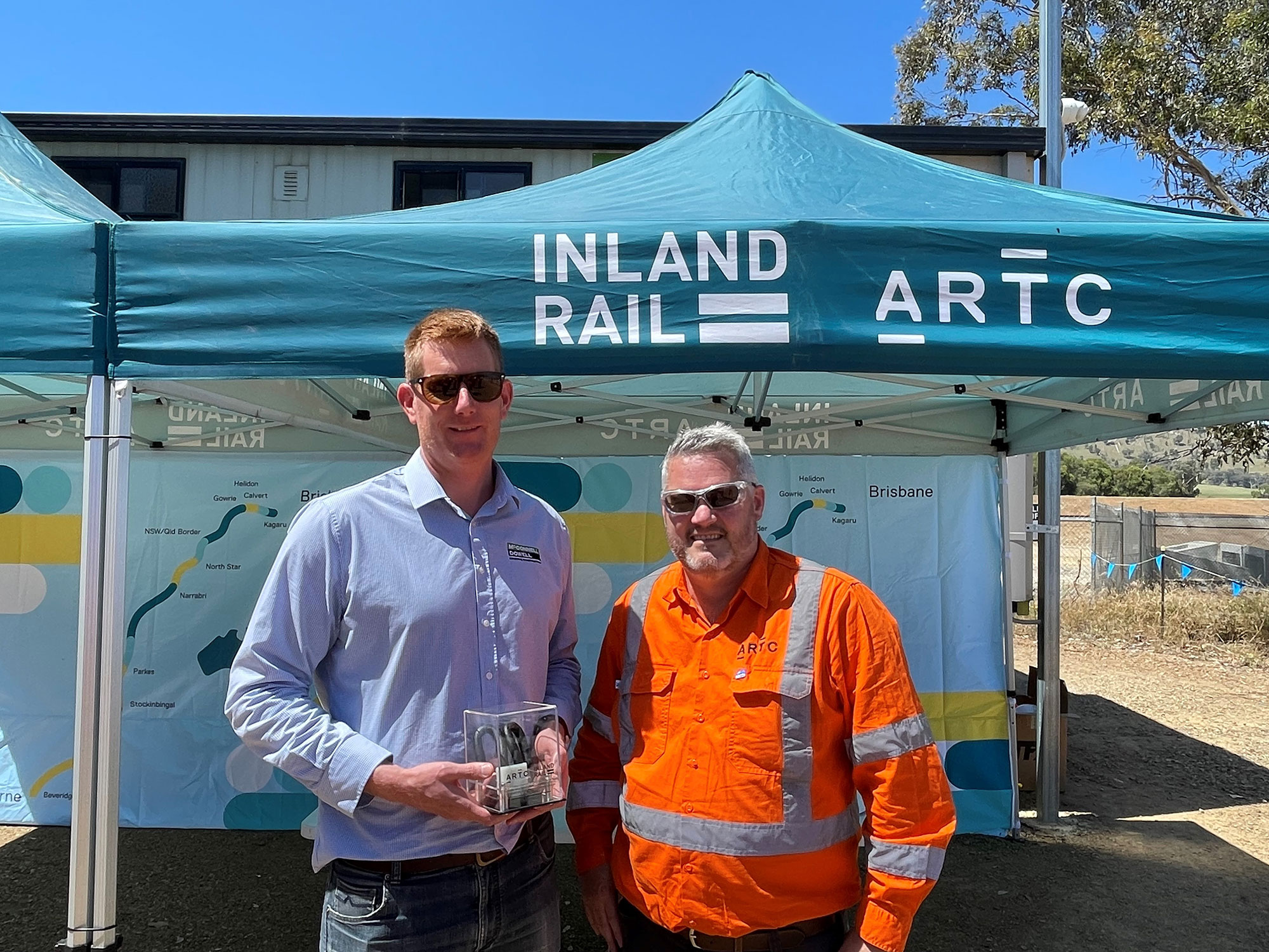 McConnell Dowell’s Tom Foley and ARTC’s Ed Walker celebrate the completion of the track lower at Murray Valley Highway Barnawartha North