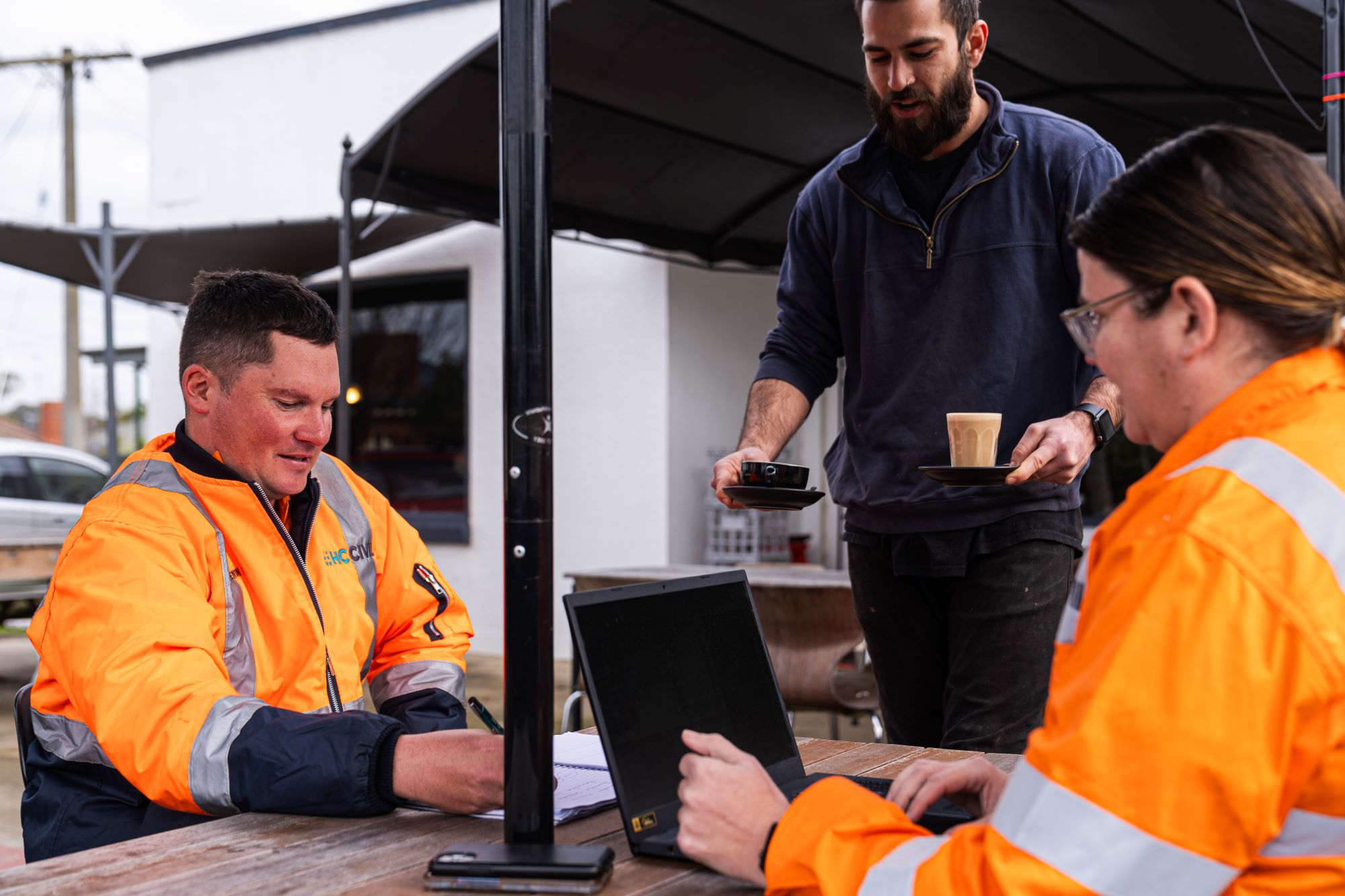 Two Inland Rail workers having a meeting at a local coffee shop in Wangaratta.
