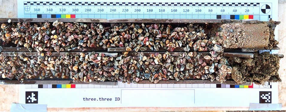 Two trays filled with soil and small rocks, with a ruler next to it. These components make up a soil test result.